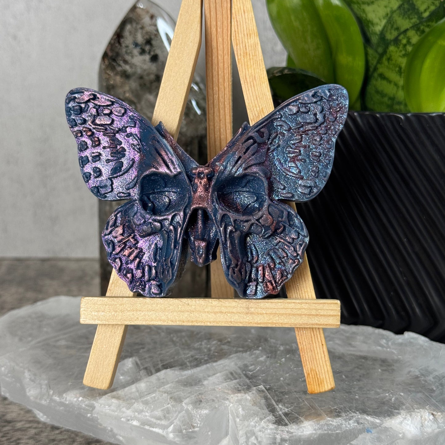 Decorative butterfly with wooden sticks on a textured surface