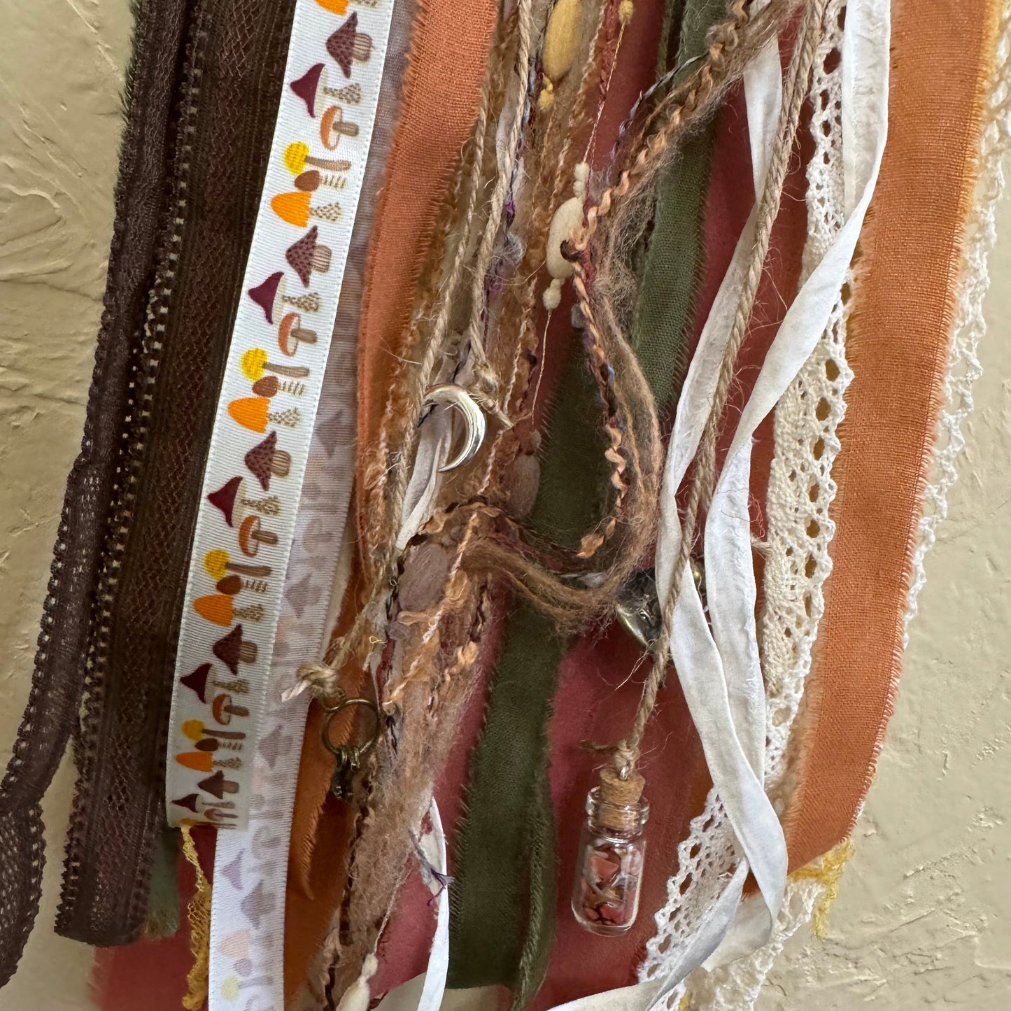 Collection of ribbons and fabric strips in various colors and patterns.