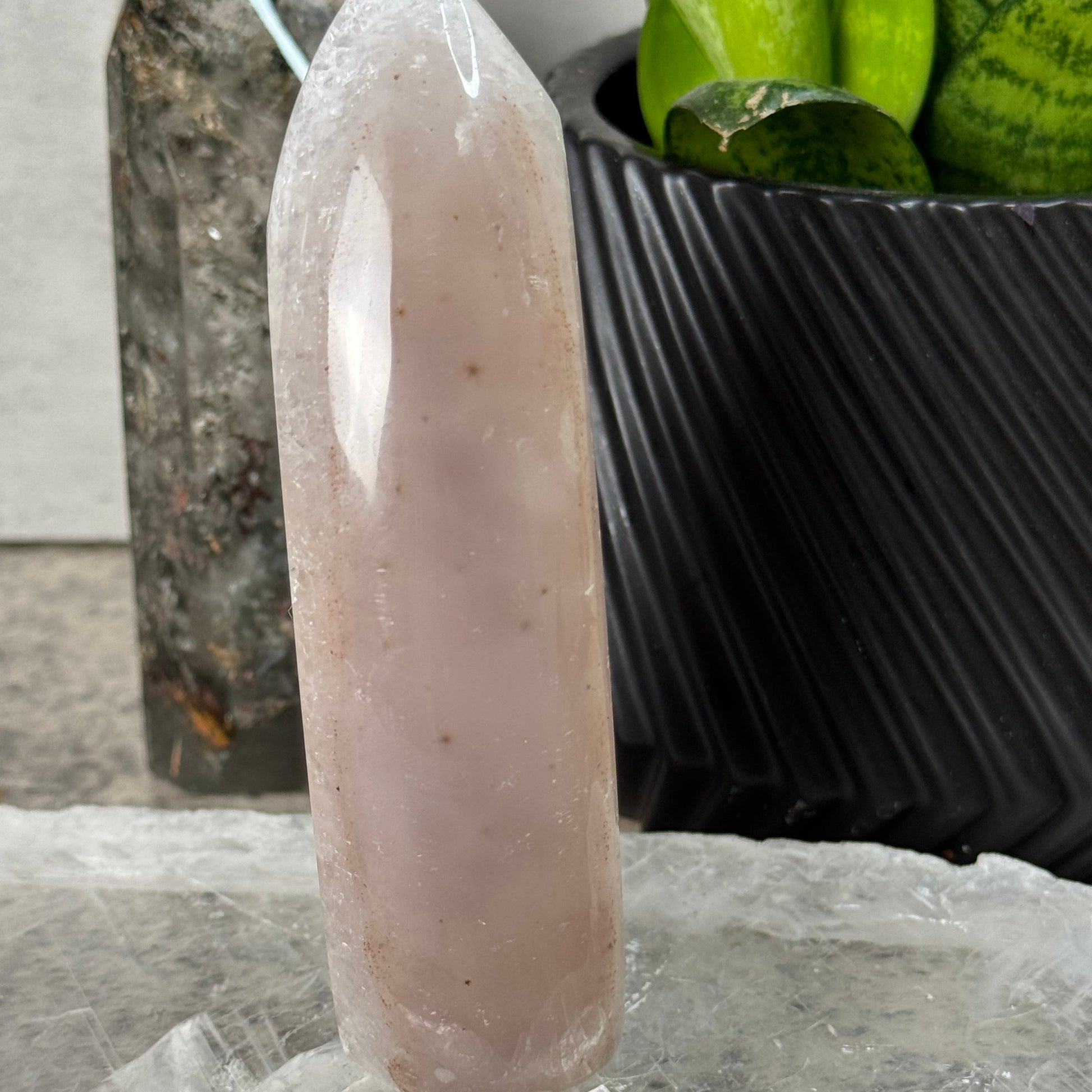 Crystal handle on a black background with green leaves in the corner