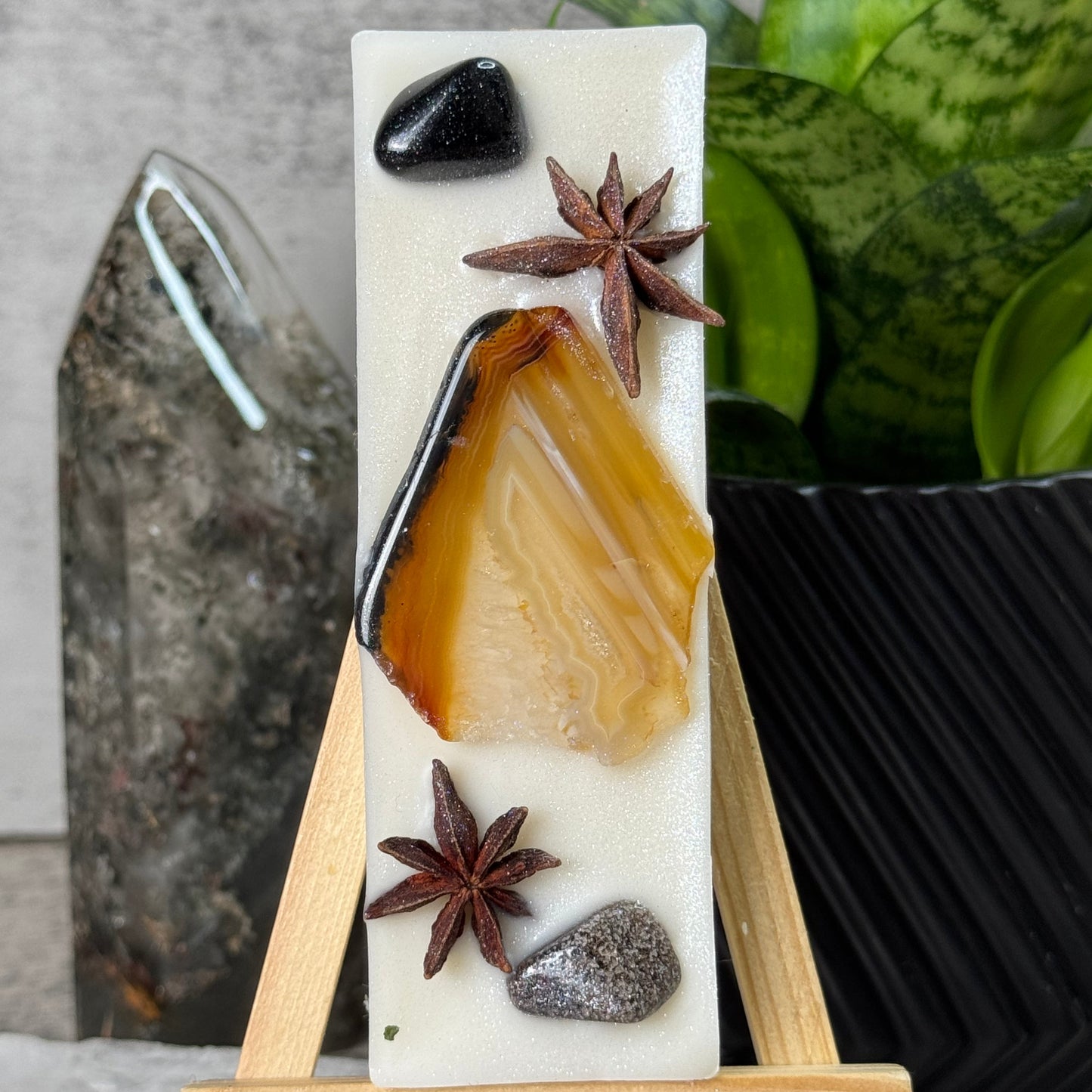 Decorative soap bar with star anise and black stone on a white background