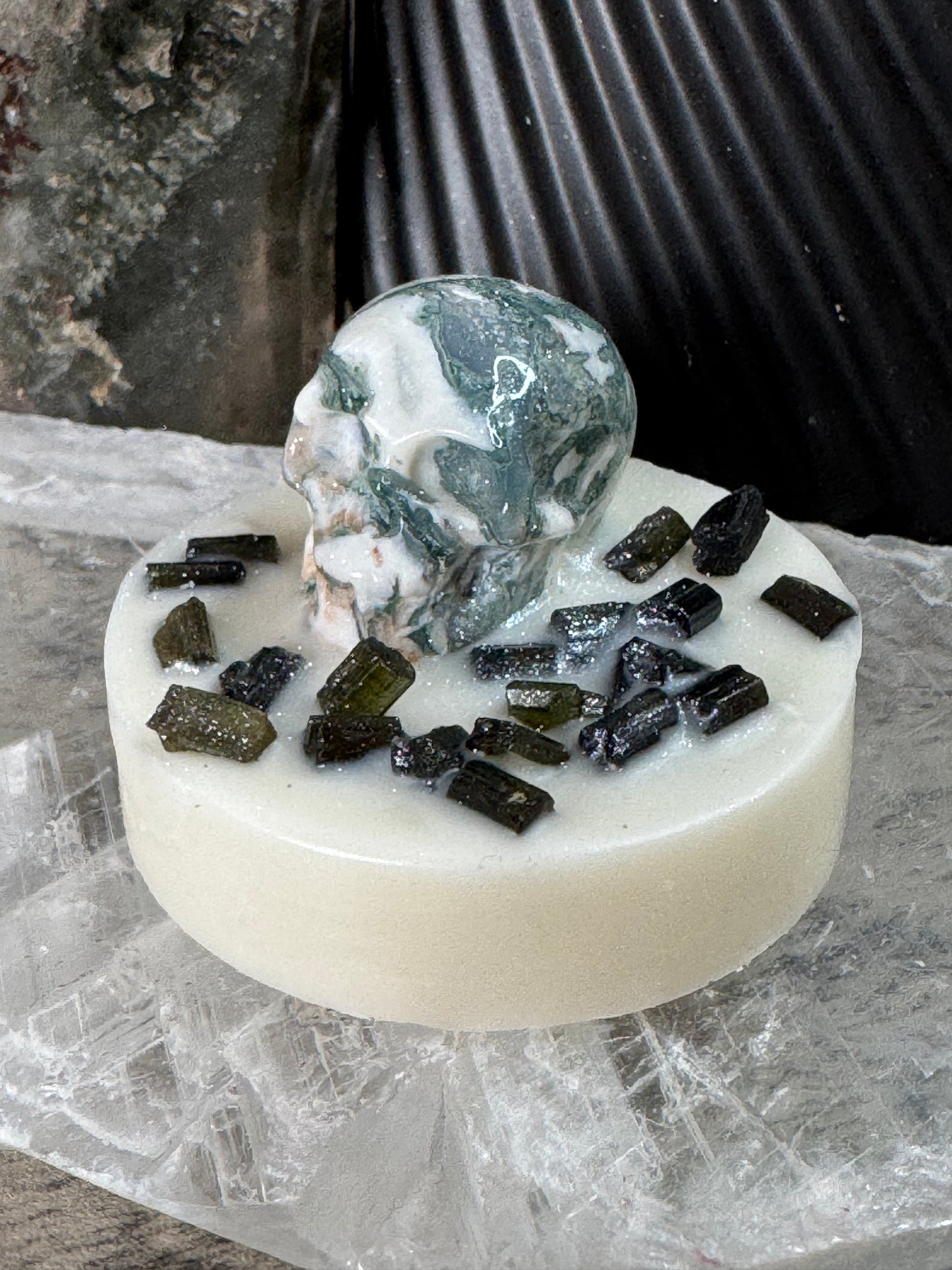 Bar of soap with活性炭inclusions on a textured surface
