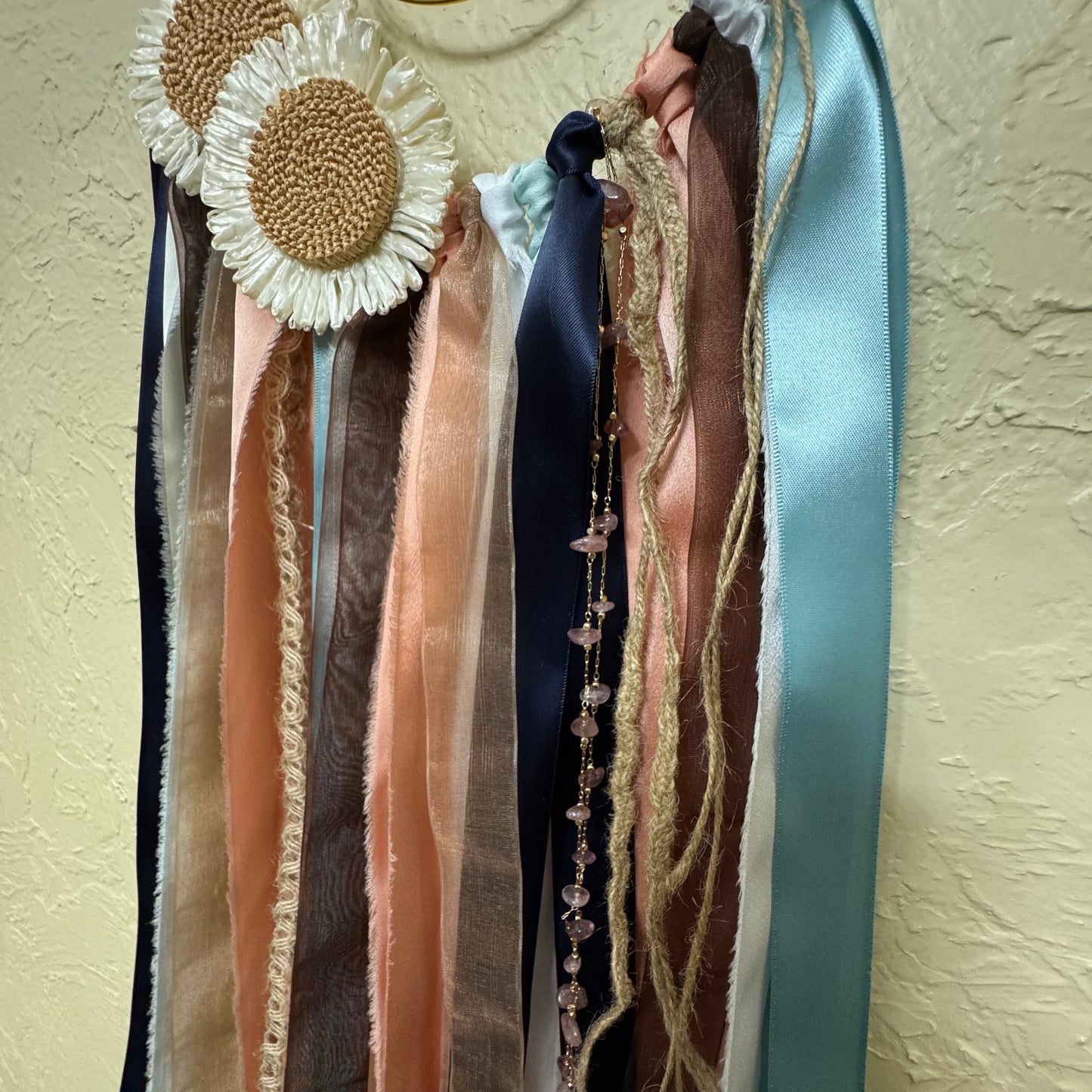 Collection of ribbons and decorative items on a textured surface