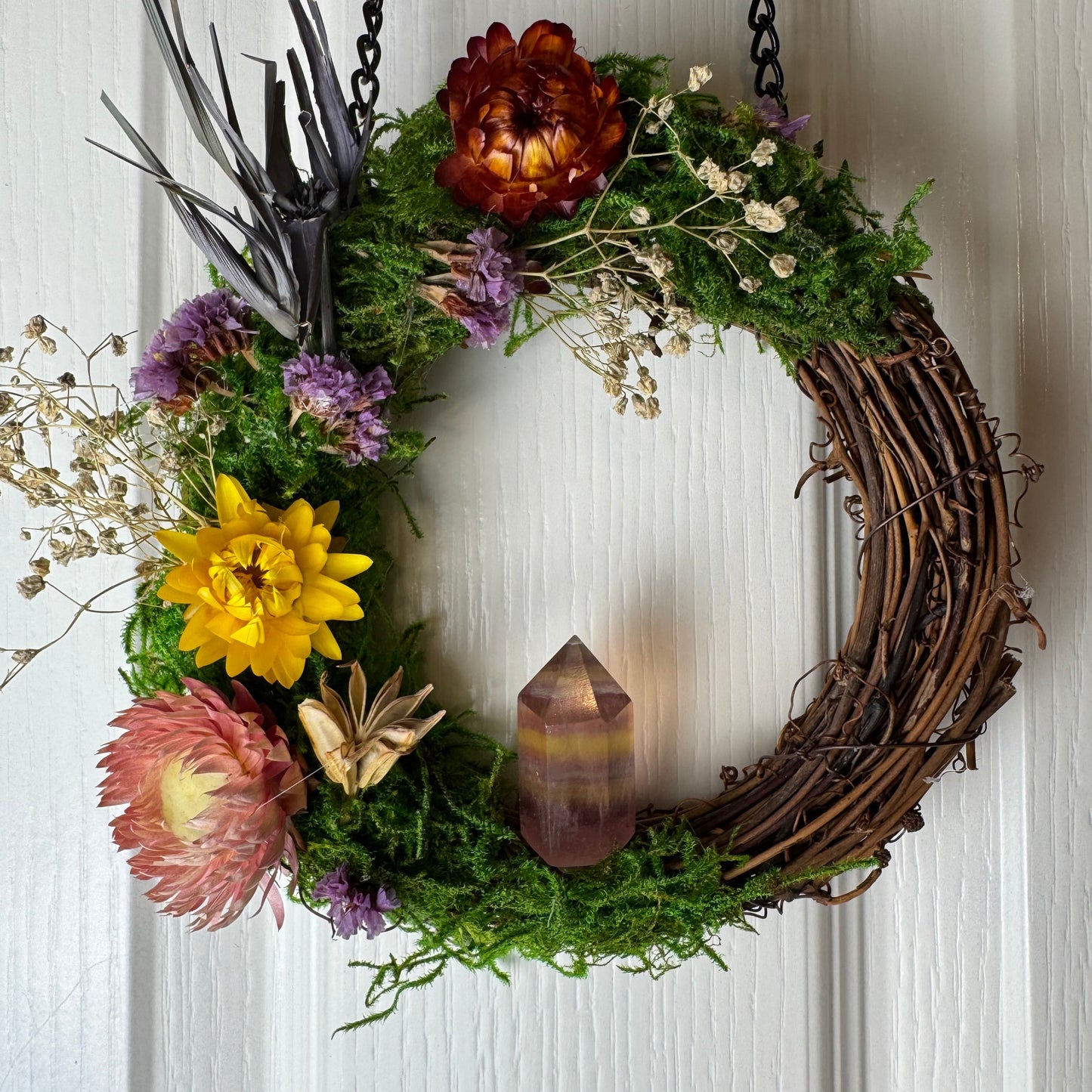 Decorative wreath with flowers and crystals on a white background