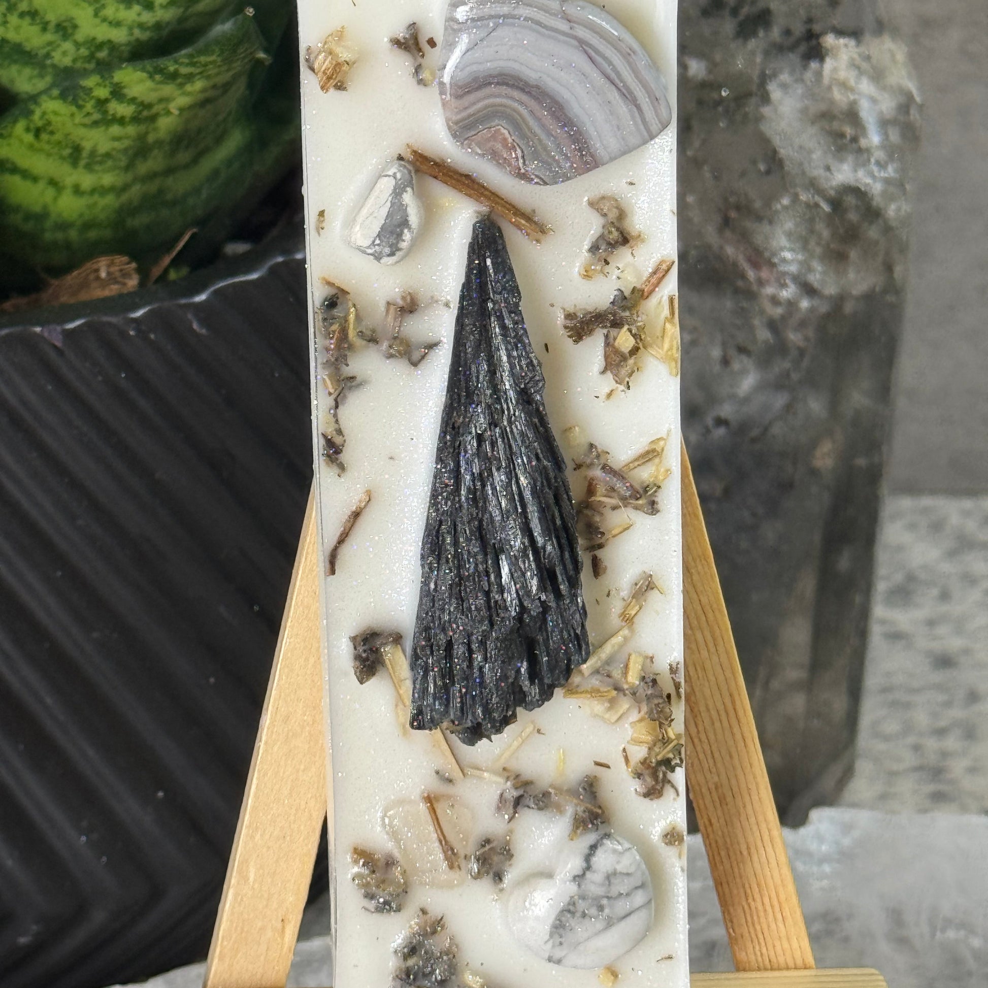 Decorative stone with natural patterns on a wooden stand, with a blurred background