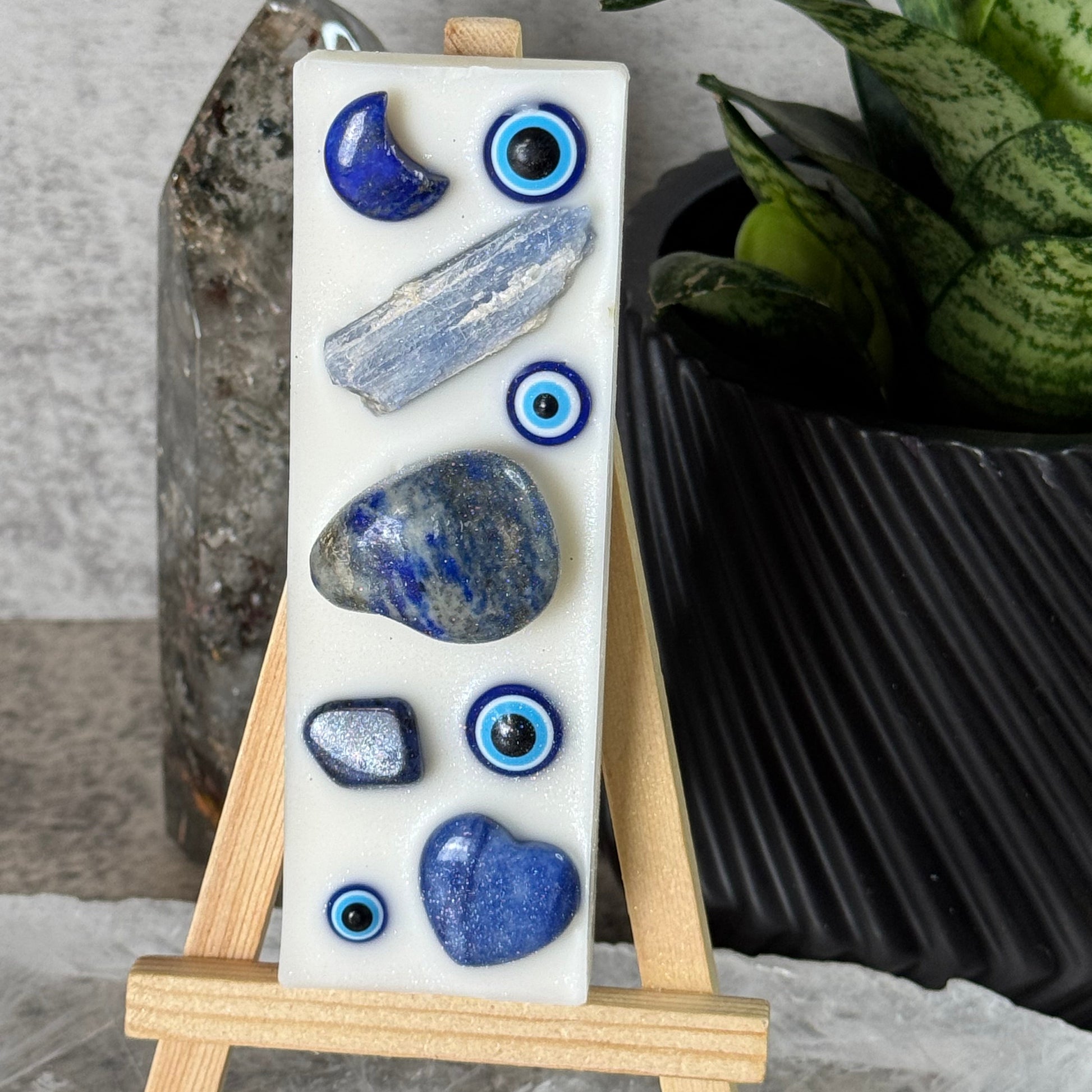 Decorative stone set on a stand with a plant in the background