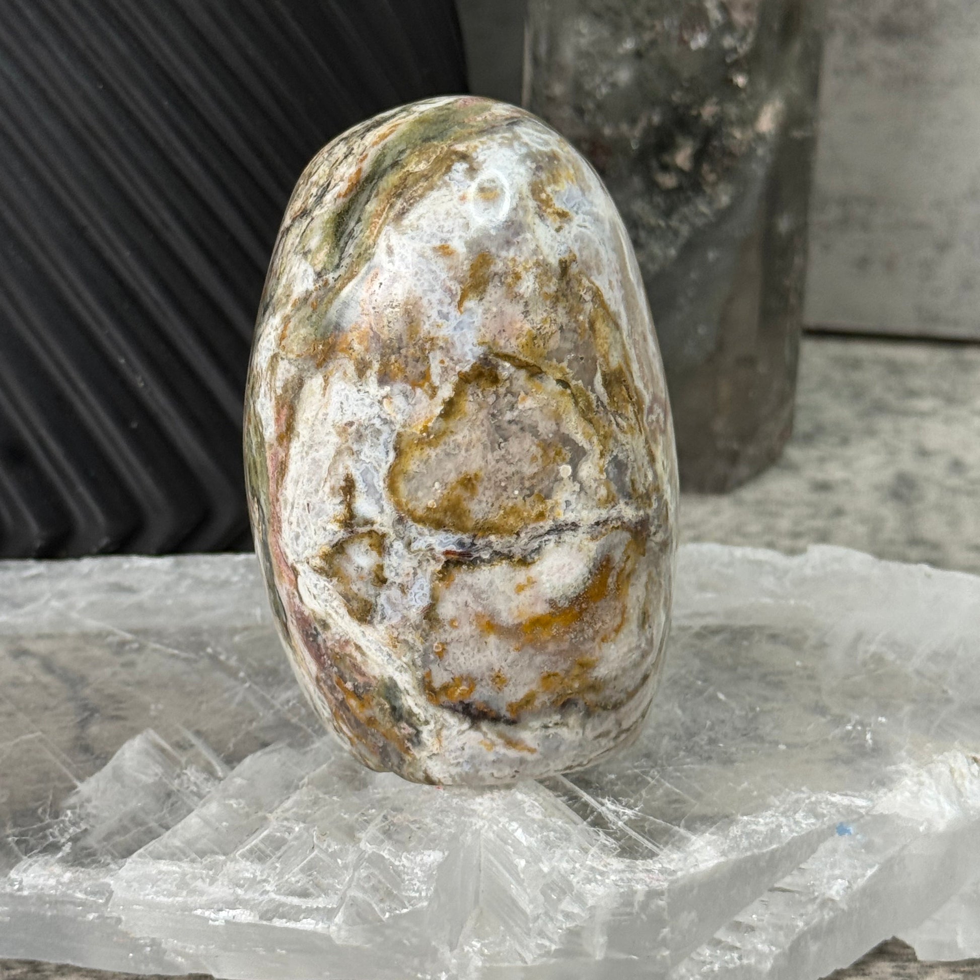 Oval-shaped stone with a rough texture on a blurred background
