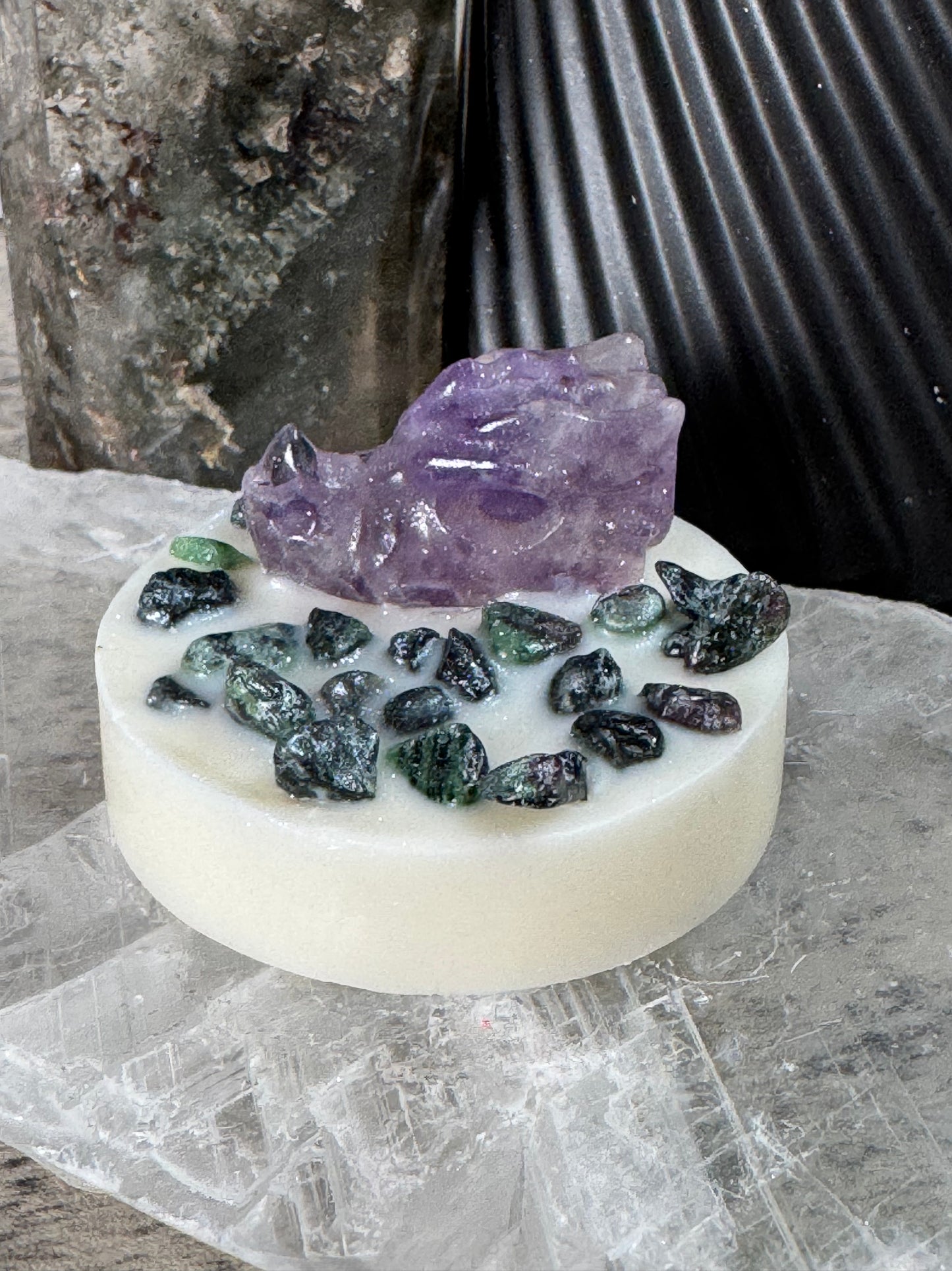 Soap bar with embedded stones on a textured surface