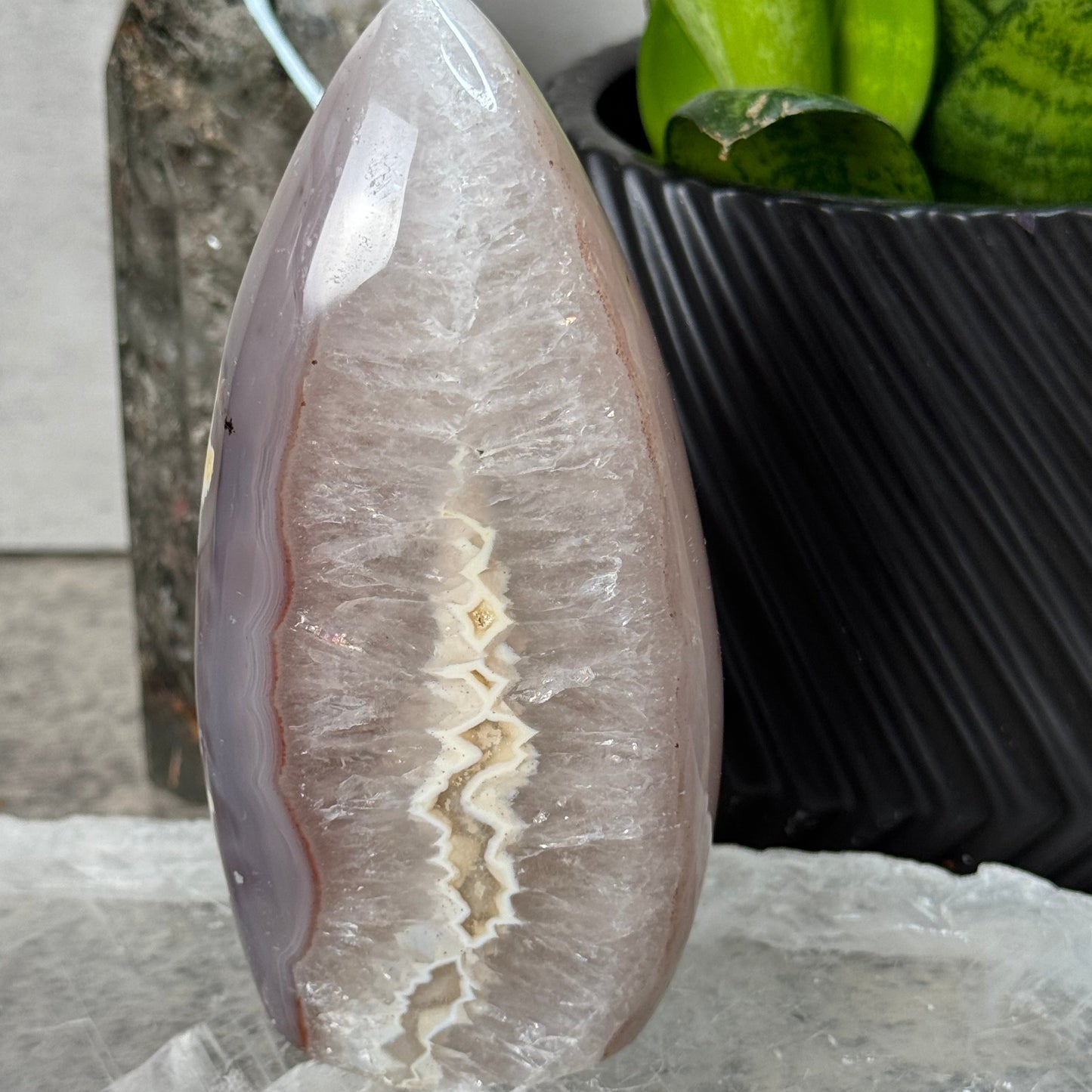 Decorative stone with a white center and brown edges on a marble surface.