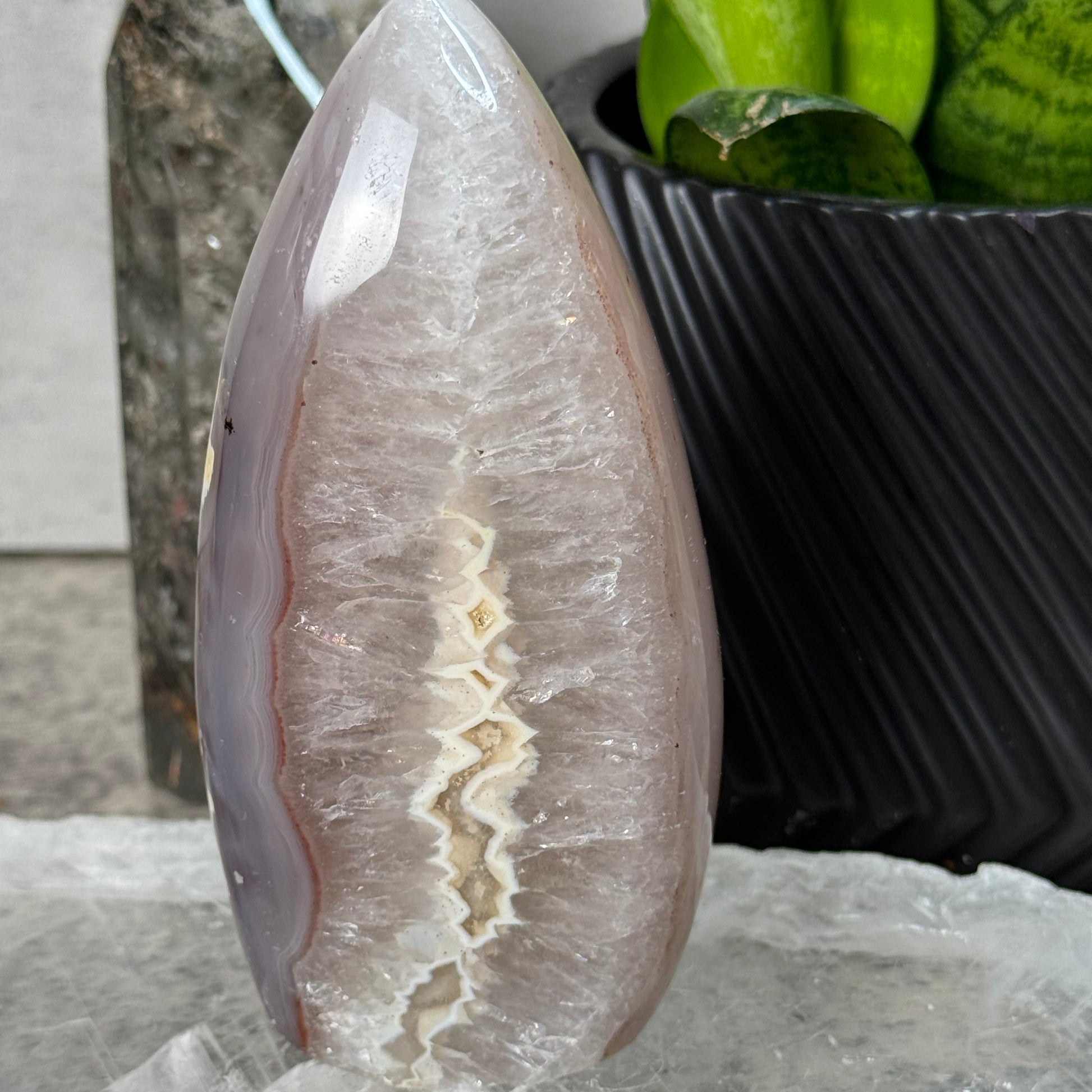 Decorative stone with a white center and brown edges on a marble surface.