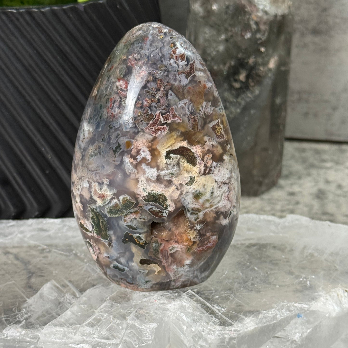 Rusty metal object on a concrete surface with a plastic bag in the background