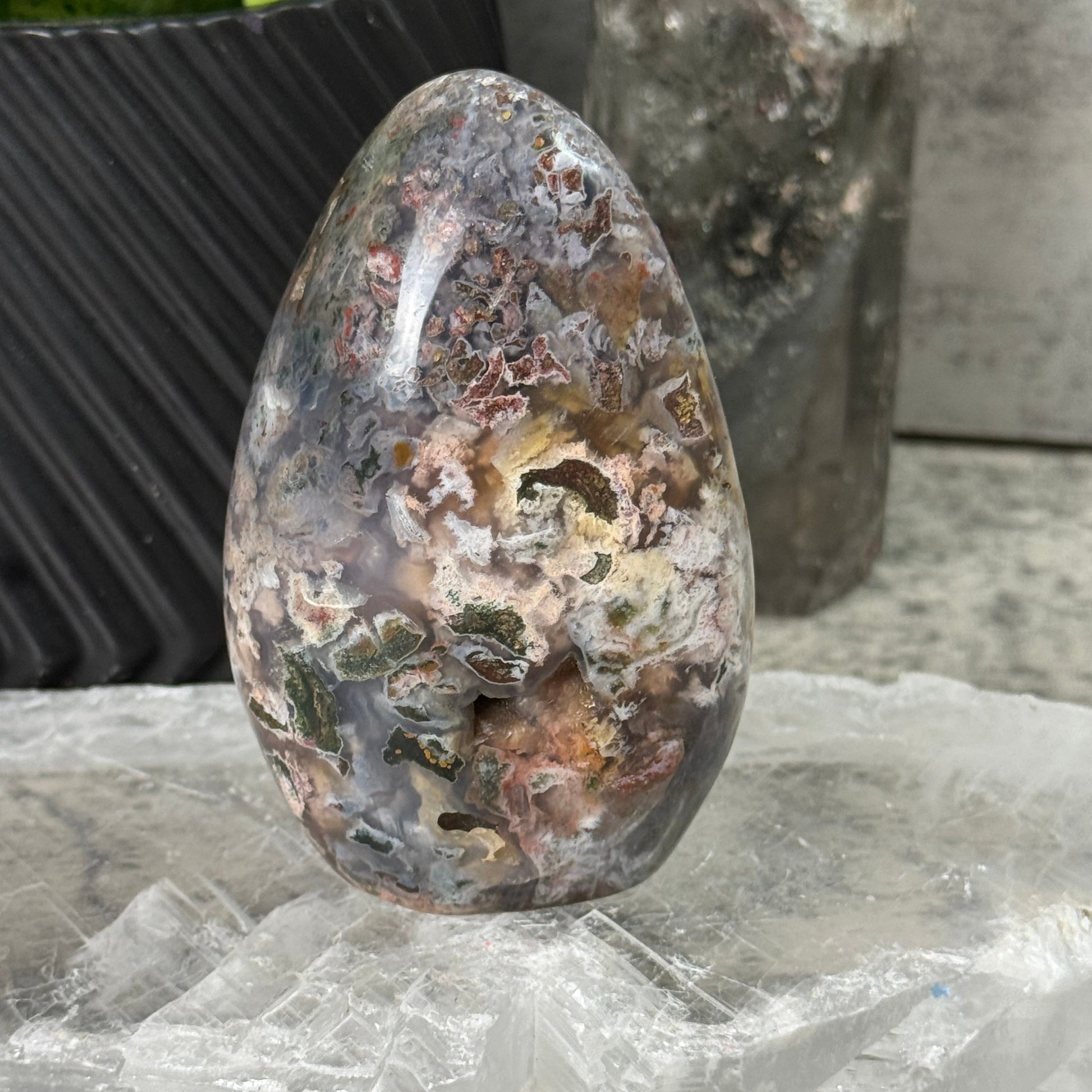 Rusty metal object on a concrete surface with a plastic bag in the background