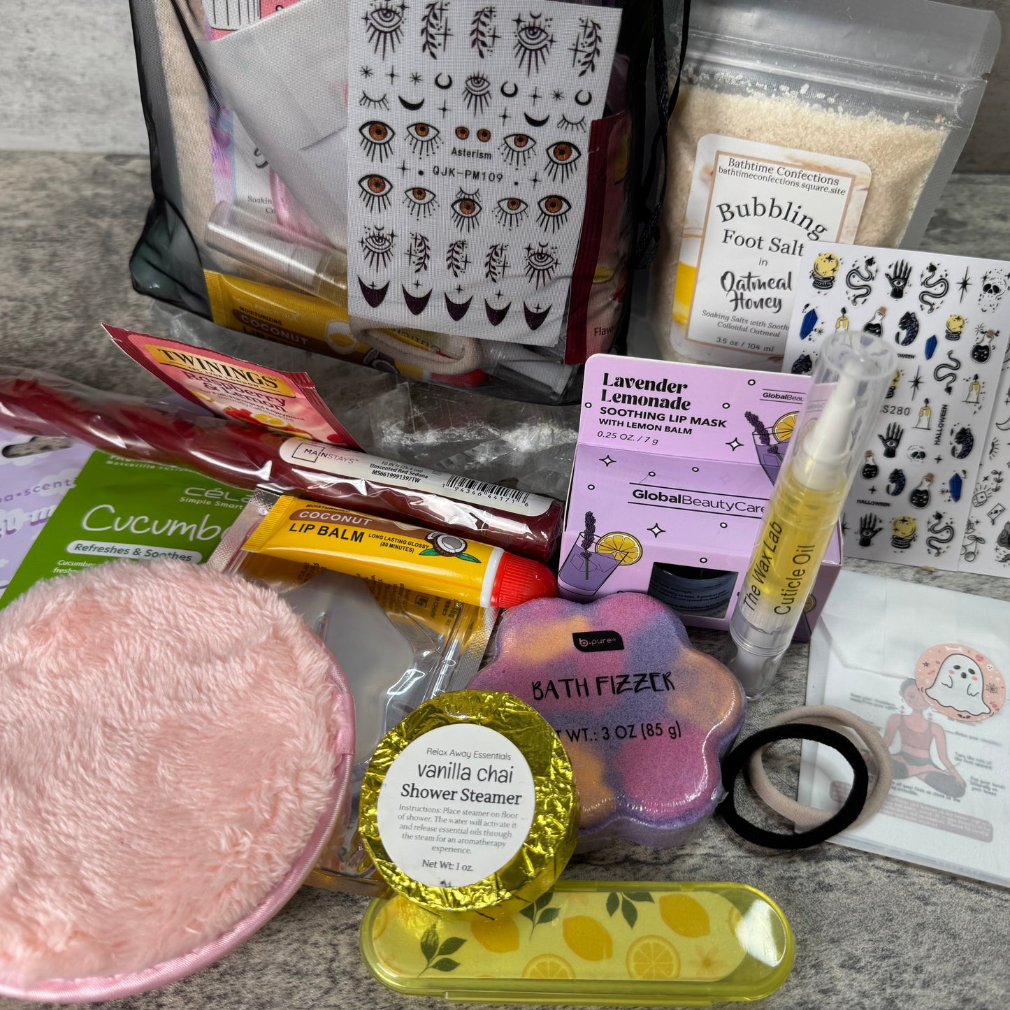 Collection of self-care products including bath bombs, foot salts, and skincare items on a countertop.
