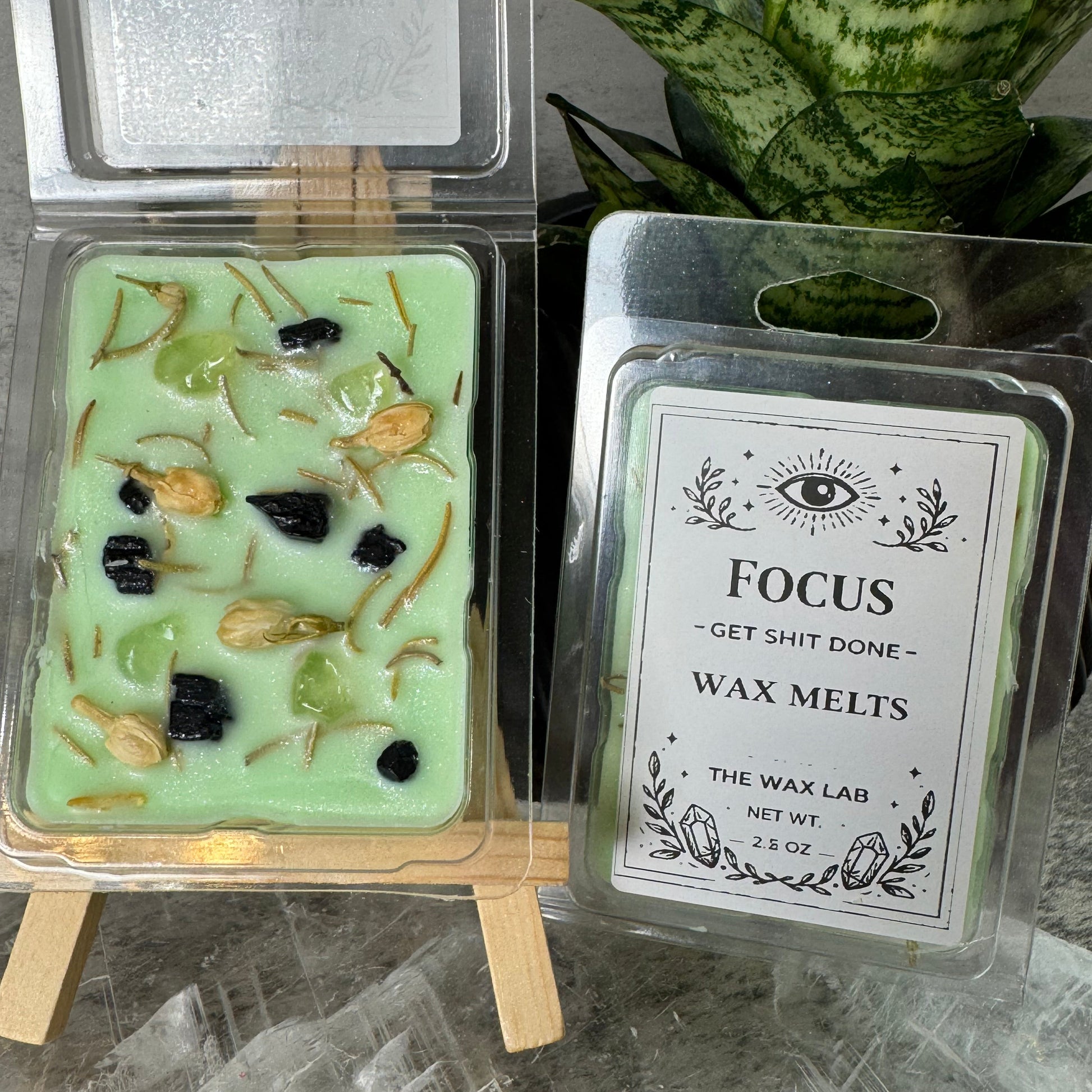 Wax melt packaging with visible ingredients on a marble surface
