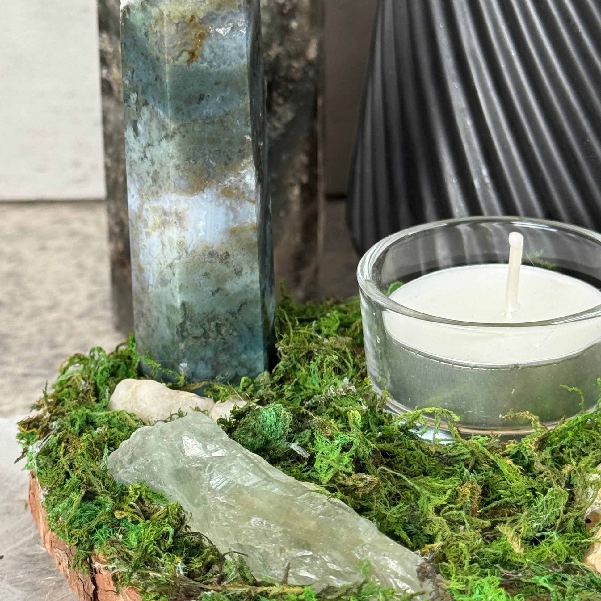 Crystal and candle on a natural background