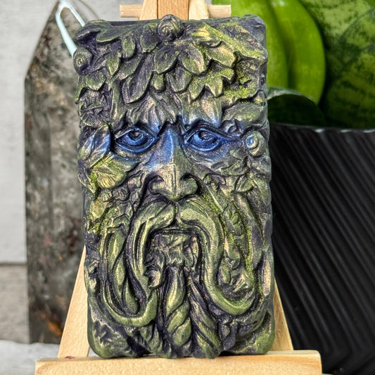 Decorative soap bar with intricate design on a wooden holder.