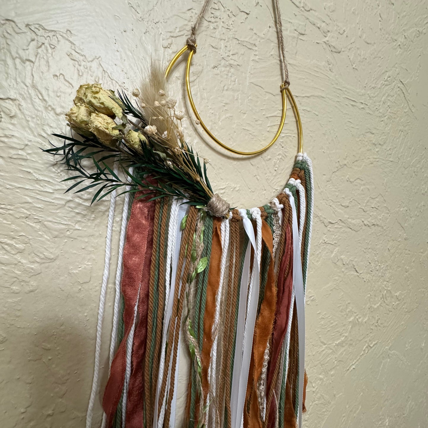 Colorful feathered hair accessory on a neutral background