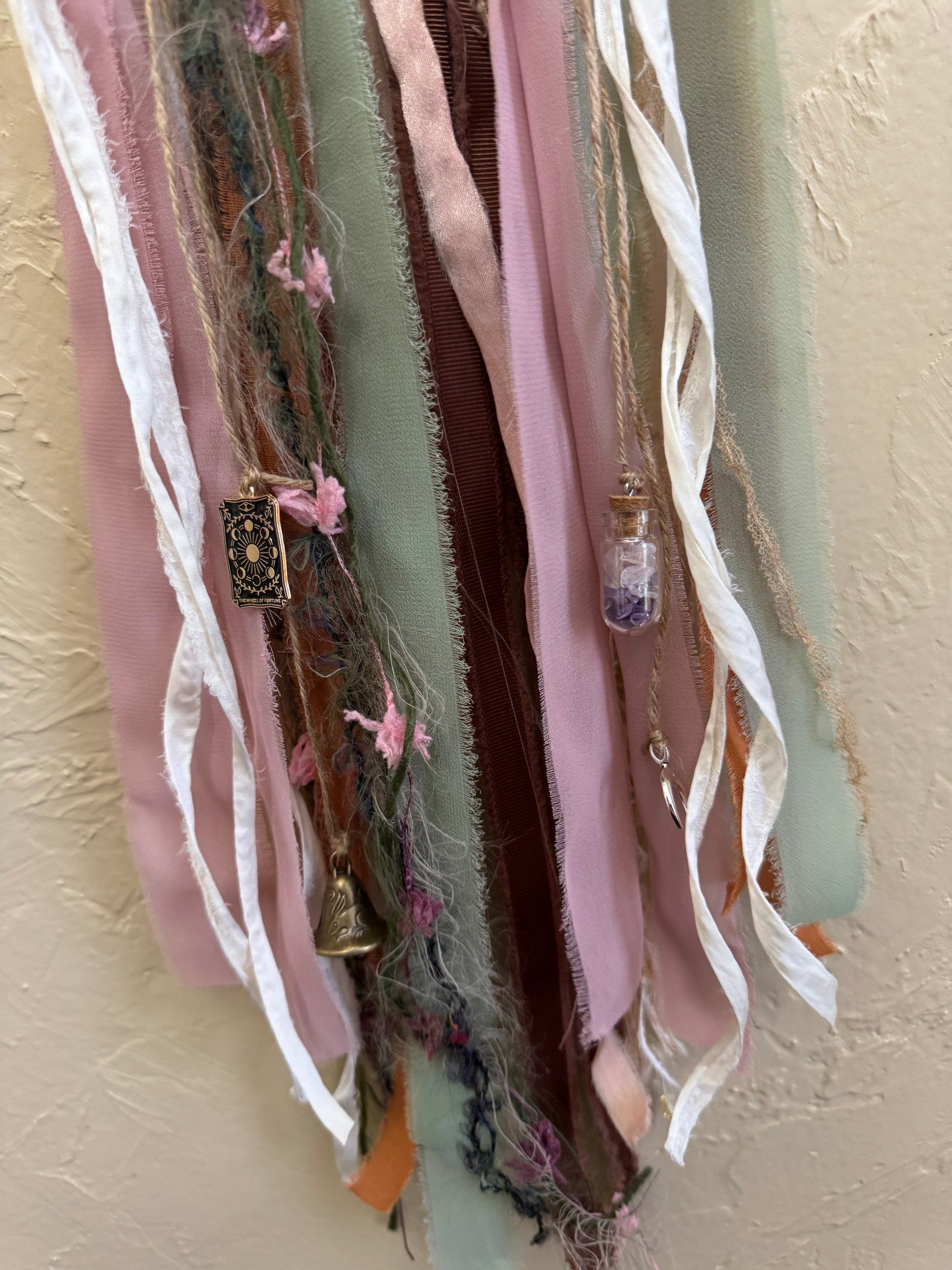 Collection of ribbons and decorative items on a beige surface