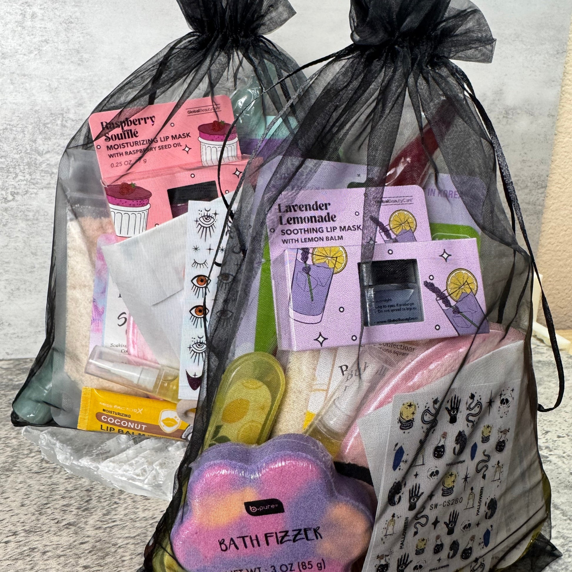Bag of beauty products including a pink palette and a purple container on a light gray surface.