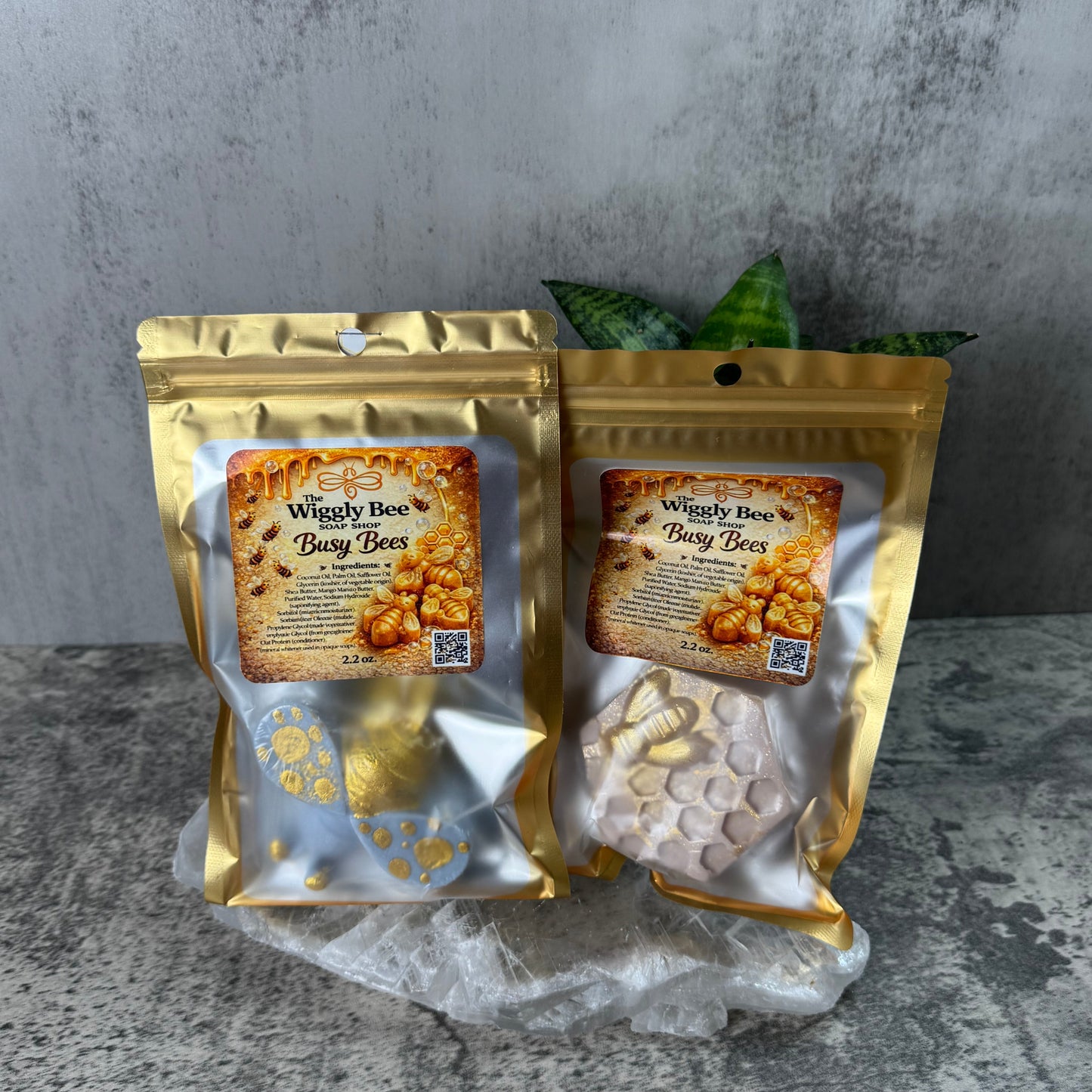 Two gold packages with labels on a gray surface