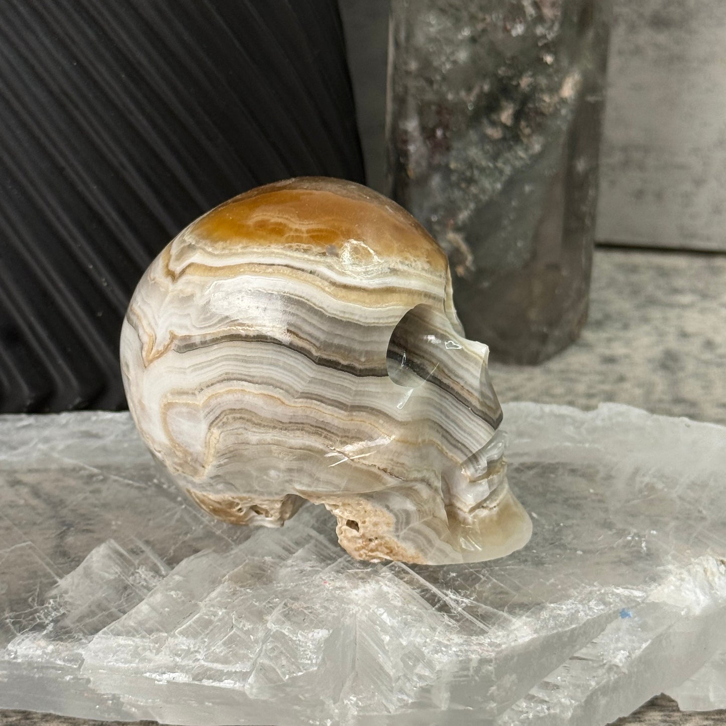 Decorative stone with wavy patterns on a textured surface