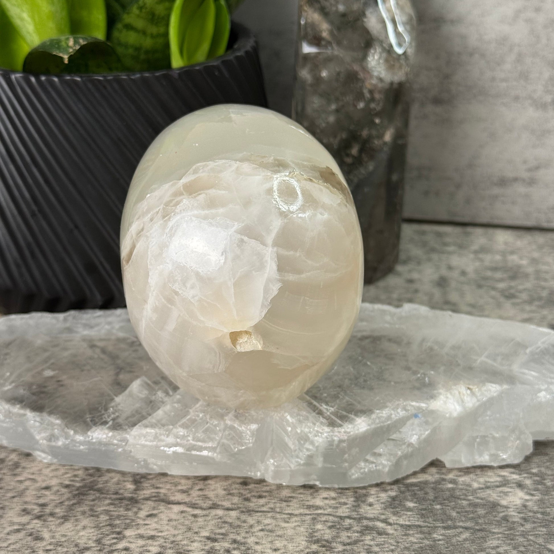 Decorative stone with a candle inside on a stone surface