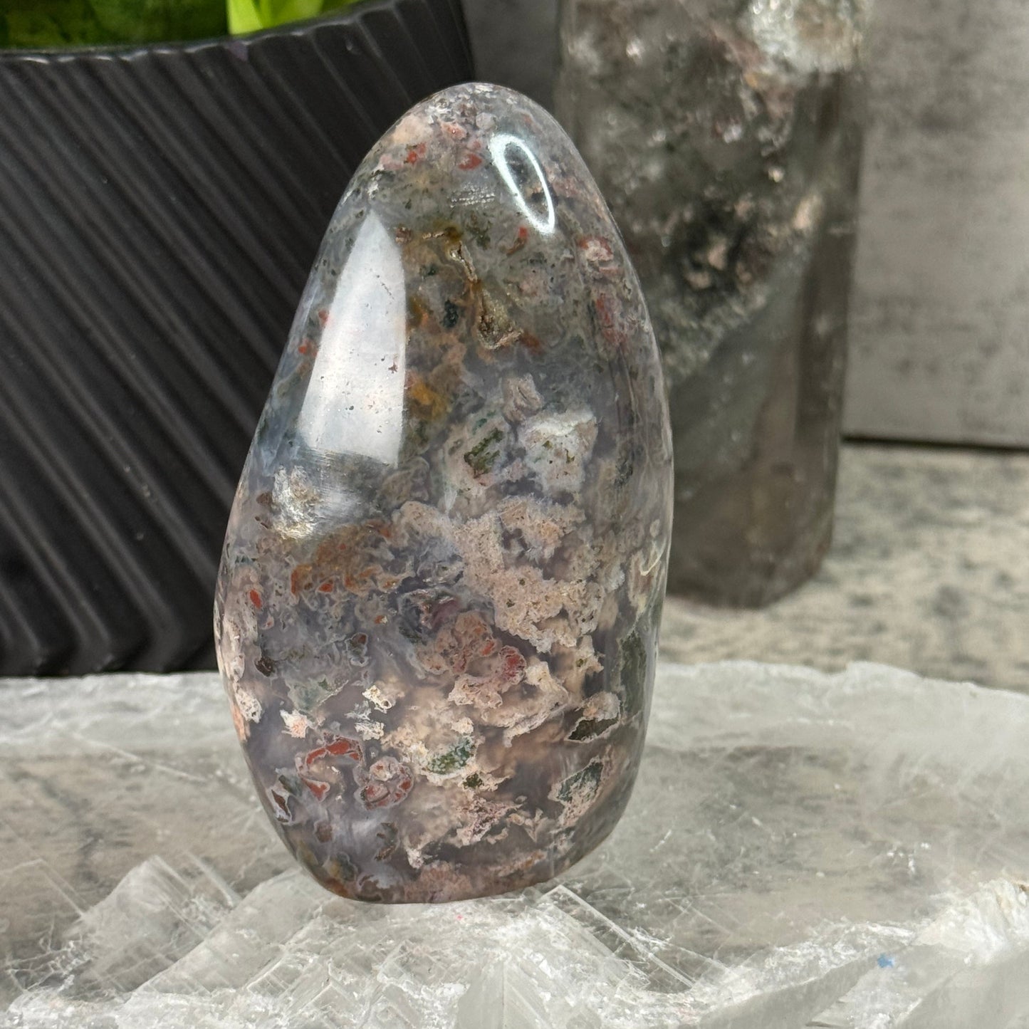 Polished stone with natural patterns on a textured surface