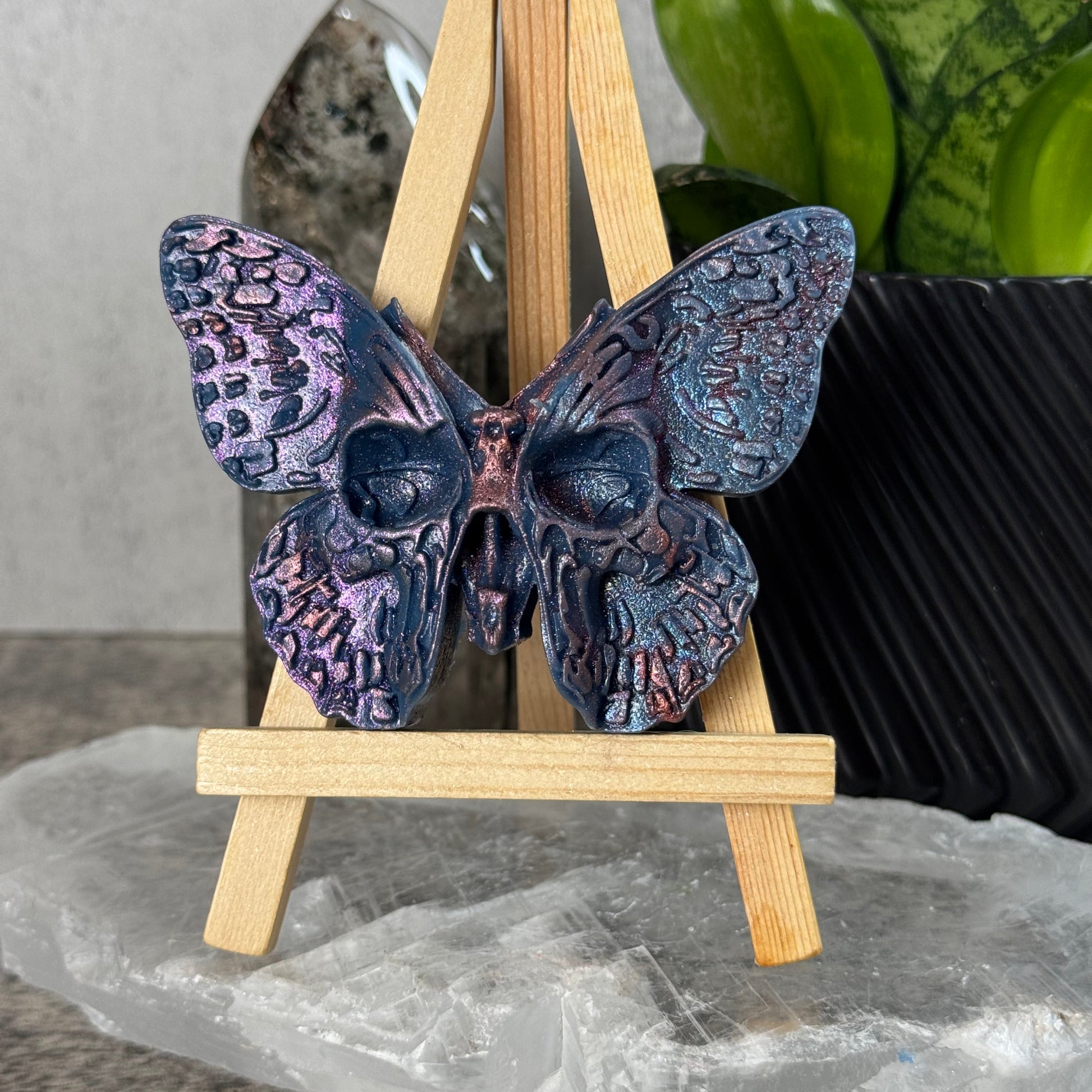 Decorative butterfly with wooden sticks on a textured surface