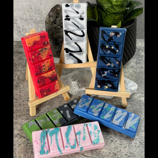 Colorful ice cube trays with various designs on a gray surface.