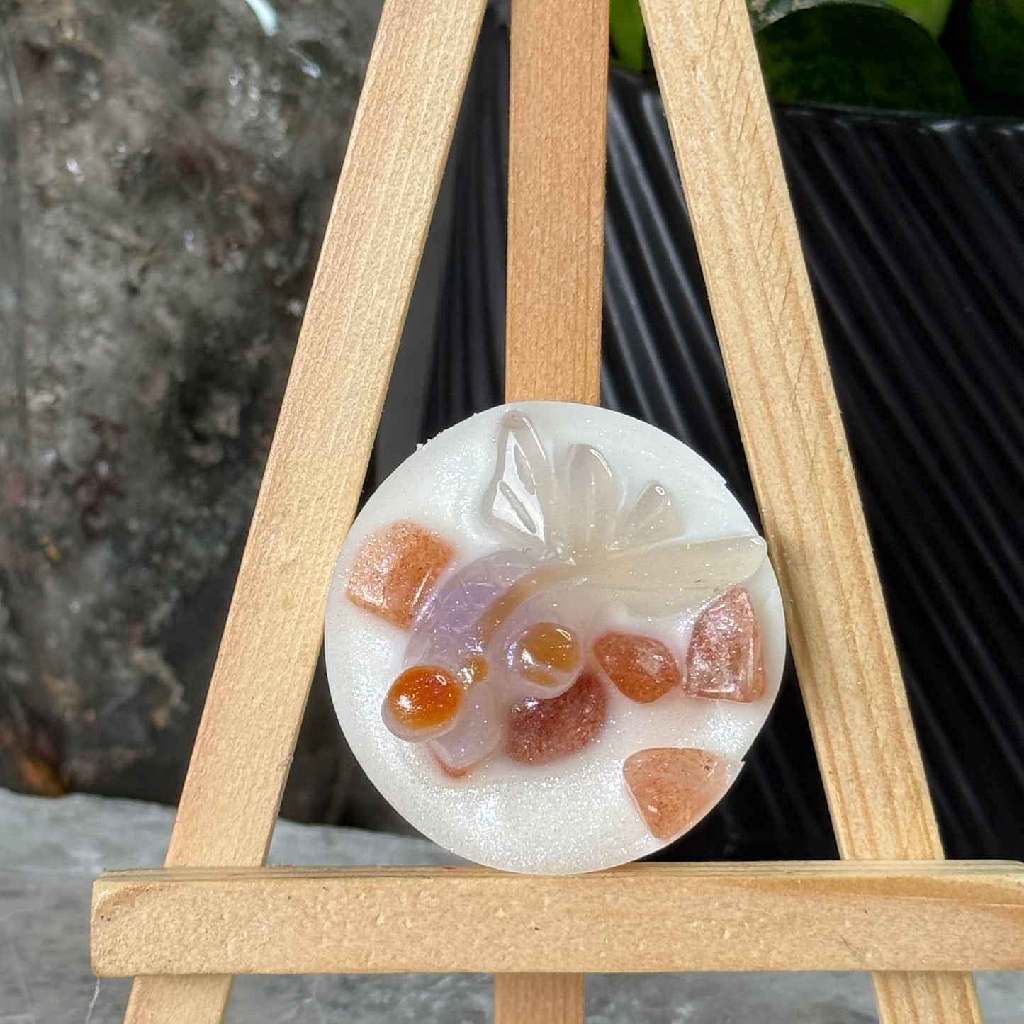 Round dessert with fruit pieces on a wooden stand