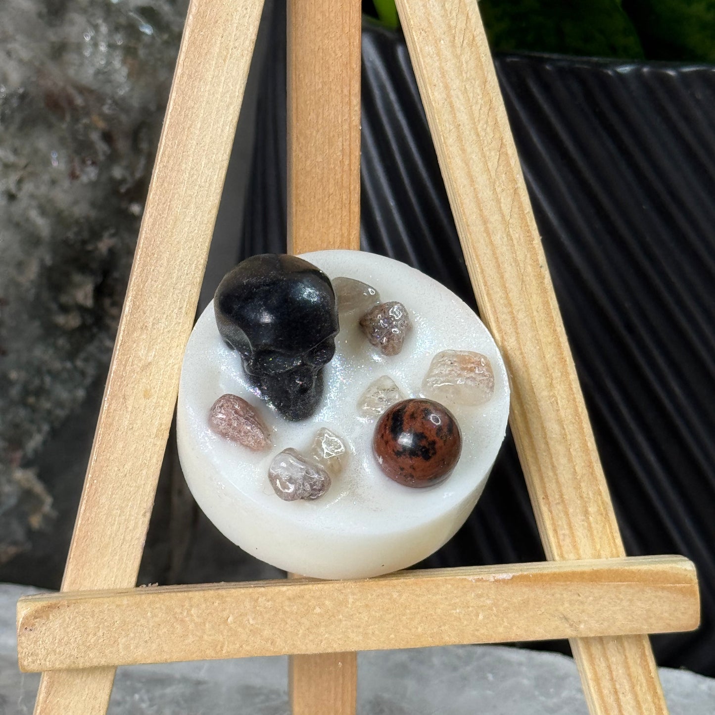 White round soap with embedded stones on a wooden stand
