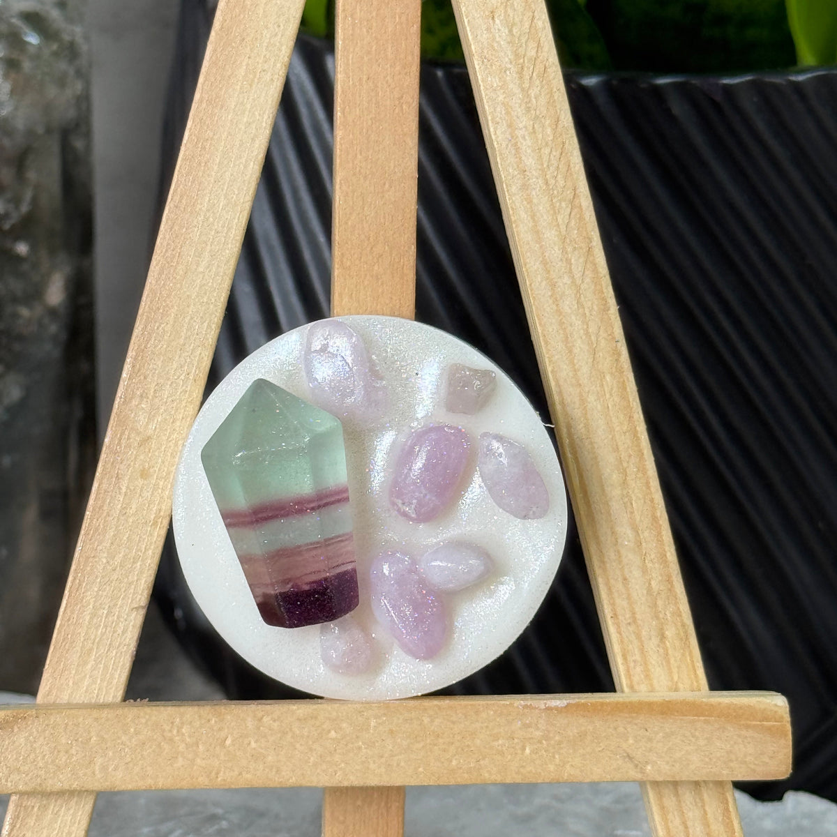 Close-up of a gemstone in a mold with wooden sticks around it.